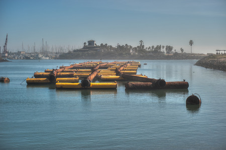 Foggy marina used as staging area for pipe used to dredge Ventura Harbor.