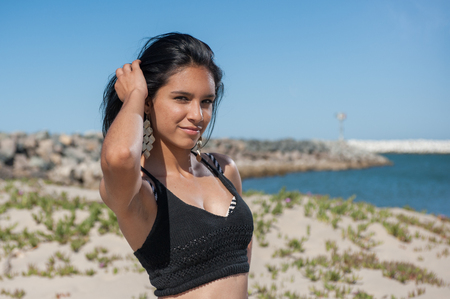 Sexy female close view posed in front of beach jetty in Ventura.の写真素材