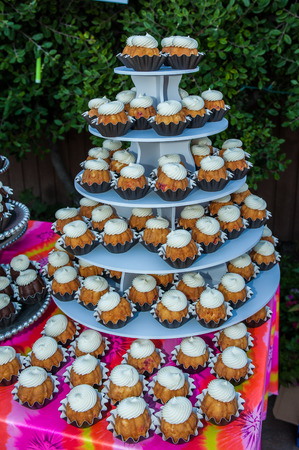 Hospitality accommodations feature a tower of mini bundt cupcakes with swirled frosting.の写真素材