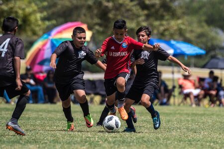 Players on the red La Esperanza battle with the black Ventura County Soccer Club jerserys for control of the soccer ball at Kimball Park on August 19, 2018 in Ventura, California.のeditorial素材