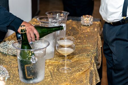 Champange poured into glass flute arranged on table and ready for party goer to drink delicious...