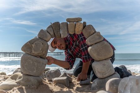 Juan Manuel Cisneros looks through the stone opening while constructing the arch engineered from...
