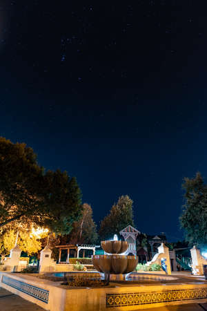 Plaza fountain springs water at Ojai park under stars in the night sky.の写真素材
