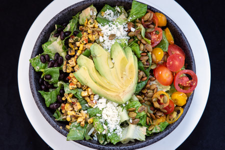 Overhead view of delicious hearty bowl of New Mexico Salad with black beans and avocado makes the mouth water and the stomach growl.の写真素材