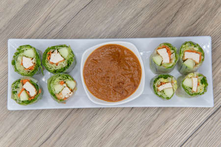 Overhead view of fresh rolls for that vegetarian craving with tofu and dipping sauce.