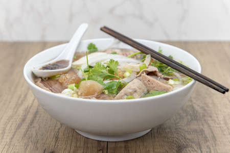 Hearty bowl of Pho loaded with meat, broth, and special taro sauce for a complete meal.