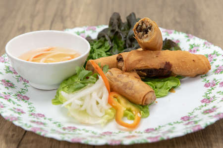 Hearty appetizer of deep fried egg rolls cooked to crispy perfection served with dipping sauce.