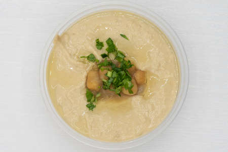 Overhead view of baba Ganoush salad presented in a clear bowl for a Mediterranean meal on the go.