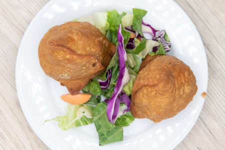 Overhead view of deep fried appetizer samosa potato from Indian restaurant cooked and seasoned...