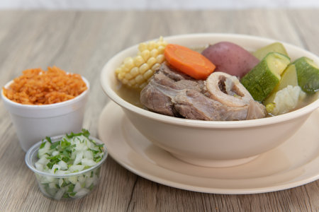 Hearty bowl of Caldo de res Mexican beef stew hot from the stove and served with rice and pico de gallo.の写真素材