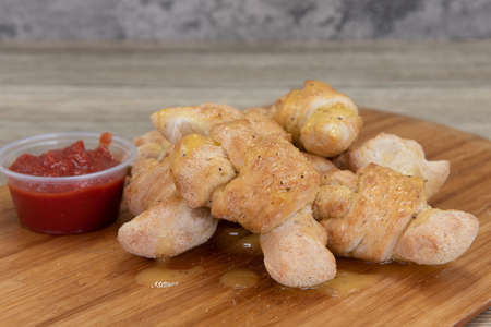 Side dish of drizzled garlic knot bread is the perfect appetizer for a hearty meal to eat.