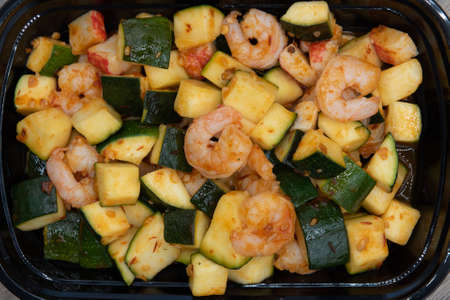 Overhead view of crabmeat, zucchini, and shrimp are all seasoned perfectly into this stir fry dish for a meal.の写真素材