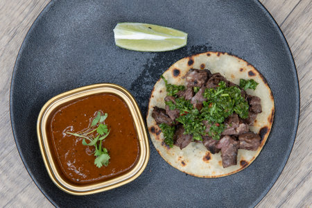 Overhead view of tasty appetizer of a steak chimichuri taco to eat before your meal.の写真素材