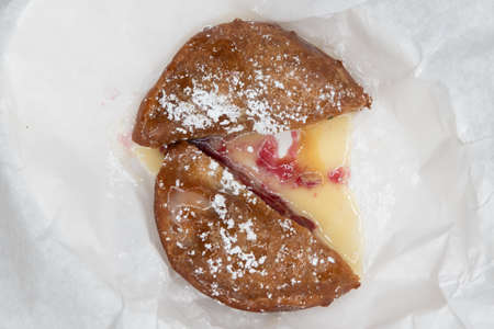 Overhead view of satisfying dessert consisting of deep fried peanut butter and jelly sandwich...