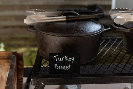 Buffet line has a cast iron pot of turkey breast for the guests to serve themselves.の写真素材