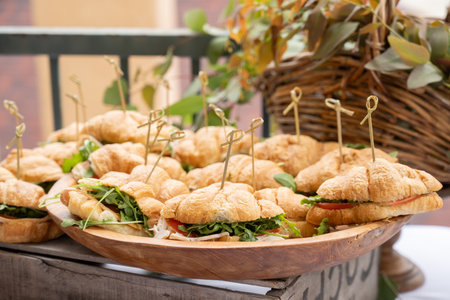 Tray full of crescant sandwiches for party guest to eat with their hands.の写真素材