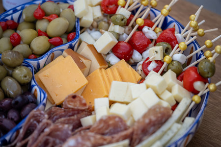 Overhead view of the buffet table is ready with charcuterie board items such as cheese and fruit for...