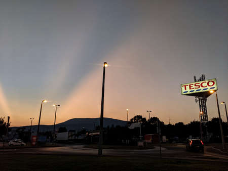 Tesco car park, parking lot after sunset with sun raysのeditorial素材
