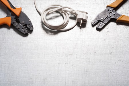 Set of electrical tool on wooden background. Accessories for engineering work, energy concept