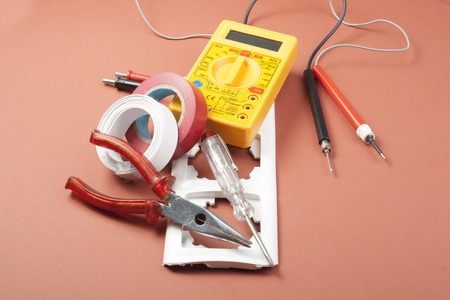 Set of electrical tool on wooden background.