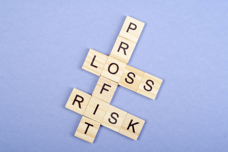 Profit, loss and risk crossword blocks on table. Top view.の写真素材