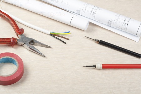 Set of electrical tool on wooden background. Accessories for engineering work, energy concept