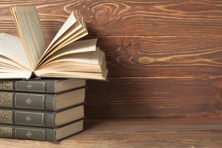 Open book, hardback books on wooden table. Education background. Back to school. Copy space for text