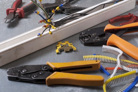 Set of electrical tool on wooden background. Accessories for engineering work, energy concept
