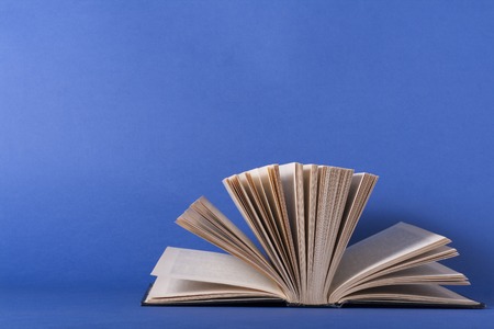 Open book, hardback books on wooden table. Education background. Back to school. Copy space for text