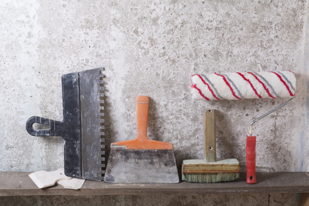 Construction tools on concrete background. Copy space for text. Set of assorted plaster trowel tools and spatula .の写真素材