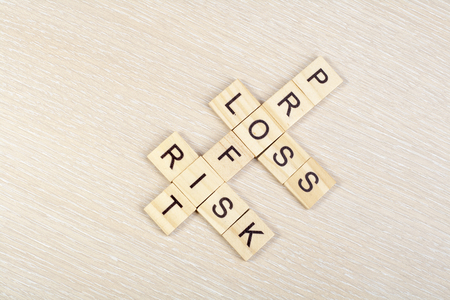 Profit, loss and risk crossword blocks on table. Top view.の写真素材