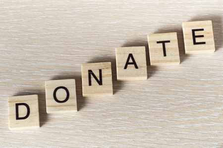 text of DONATE on cubes. Wooden abc.の写真素材