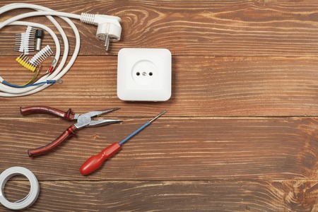 Set of electrical tool on wooden background. Accessories for engineering work, energy concept