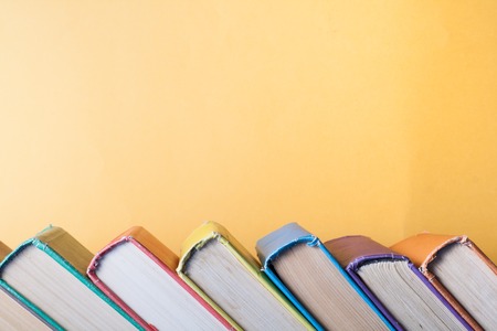 Stack of colorful books on table. Education background. Back to school. Copy space for text