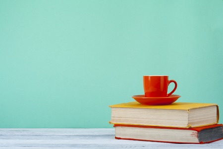 Stack of books on wooden tablle with a cup  tea. Education background. Back to school. Copy space for text.の写真素材