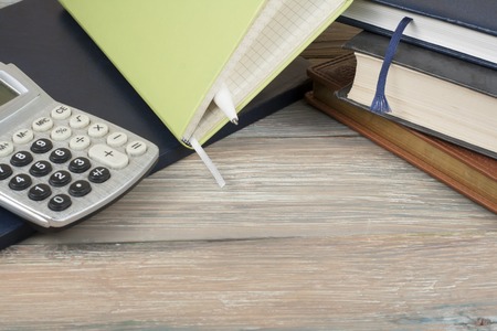 Home savings, budget concept. Notepad and calculator on wooden office table.の写真素材