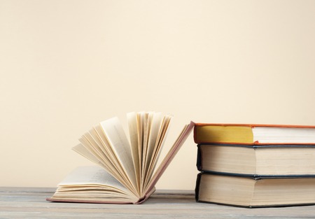 Open book, hardback books on wooden table. Education background. Back to school.の写真素材