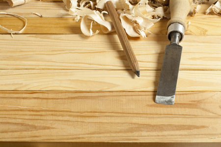 Carpentry concept.Joiner carpenter workplace. Construction tools on wooden table with shavings. Copy...