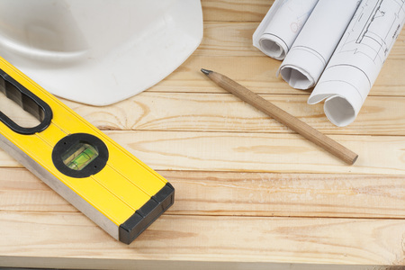 Construction tools,drawings, pencil and white helmet on wooden background . Copy space for text.
