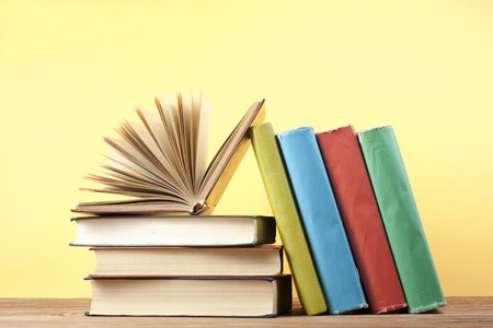 Open book, hardback books on wooden table. Education background. Back to school. Copy space for text.の写真素材