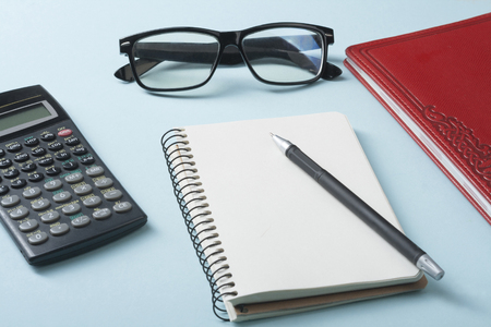 Home savings, budget concept. Calculator, pen and accounting books on office tableの写真素材