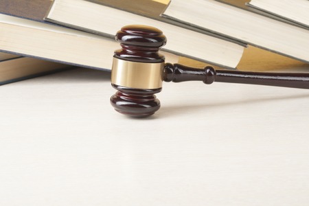 Law concept. Books with wooden judge gavel on table in a courtroom or enforcement office.