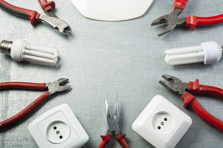 Set of electrical tools and white helmet on metallic background. Energy concept. Copy space for...