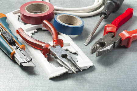 Set of electrical tools on metallic background. Energy concept.