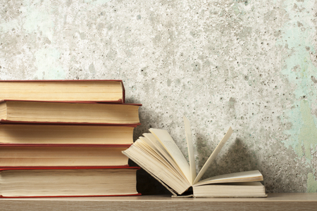Open book, hardback books on wooden table. Education background. Back to school. Copy space for text.の写真素材