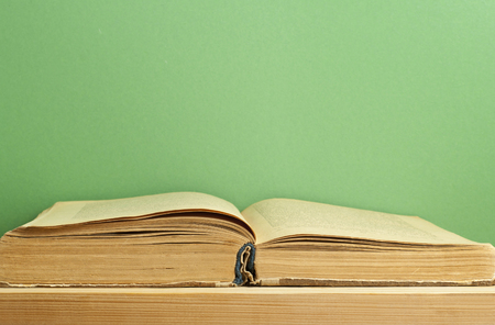 Old open book on wooden table. Education background. Back to school.の写真素材
