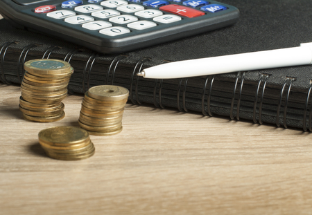 Home savings, budget concept. Calculator, pen and coins on office tableの写真素材
