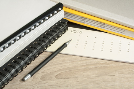 Financial and budget concept. Accounting books, pen and calendar on office table