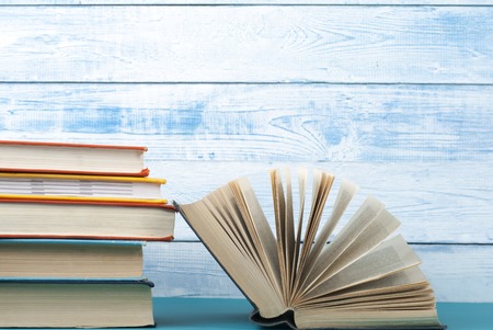 Open book, hardback books on wooden table. Education background. Back to school. Copy space for text.の写真素材