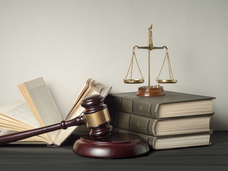 Law concept. Wooden judge gavel with law books ,scales of justice on table in a courtroom or enforcement office.の写真素材